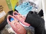 many pairs of shoes that are sitting on top of a box