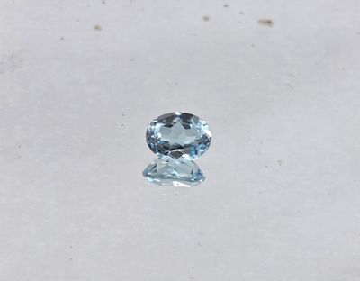 a close up of a blue topaz diamond on a white surface