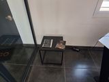 a small table with a book on it in the corner of a room