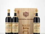 three bottles of wine in front of a wooden box