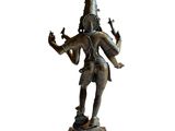 bronze statue of a man holding a bird on a pedestal