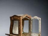 a small wooden table with a mirror on it