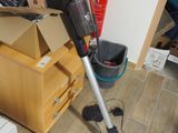 a vacuum that is sitting on the floor next to a box