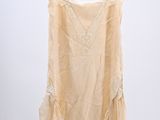 an image of a beige top hanging on a hanger