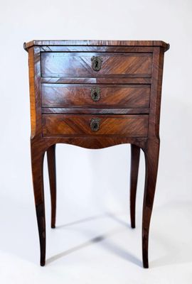 an image of a small wooden table with drawers on it