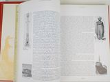 an open book with a picture of a statue in it