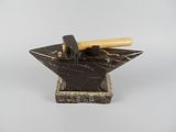 marble anvil with a hammer on top of it on a white background