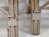 two wooden chairs that are tied together on the floor