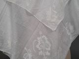 a close up of a white shawl on a mannequin head