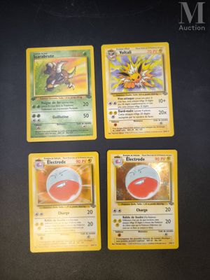 four pokemon cards sitting on top of a table next to each other
