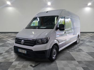la camionnette blanche est garée dans une grande pièce au sol en damier
