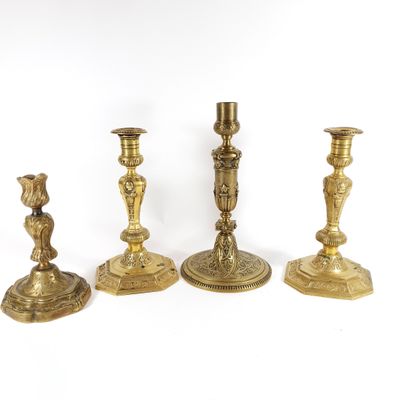 three brass candlesticks are sitting next to each other on a white surface