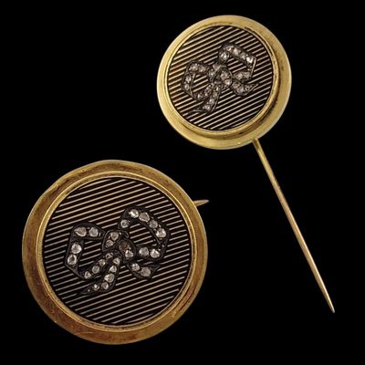 pair of gold - plated and diamond - encrusted earrings