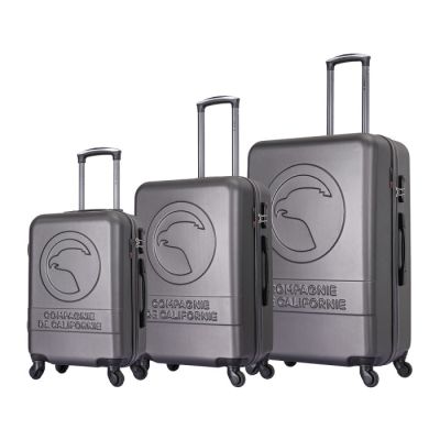 three pieces of luggage sitting on top of each other on a white surface