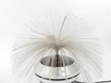 a white and black vase with a white and black ball on it