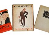 Trois livres sont alignés sur une surface blanche ; l'un représente un homme et l'autre une femme.