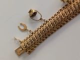 a gold bracelet with a chain attached to it