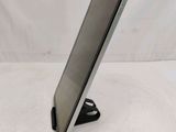 the tablet is sitting on a stand on a white surface