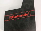 a close up of a nintendo logo on a black box