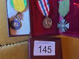 several medals and medals are in a case on a couch