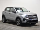 the silver suv is parked in a room with a checkered floor