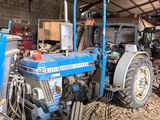 un tracteur bleu garé à l'intérieur d'un bâtiment