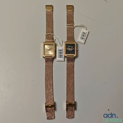 an image of a couple of watches sitting on top of a table