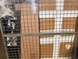 a metal cage with a bunch of boxes on it