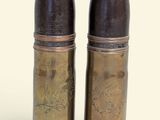 pair of antique brass salt and pepper shakers on a white background
