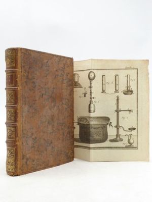 an old book opened to show a picture of a microscope