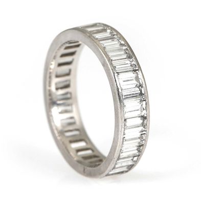 a close up of a wedding band with baguets of diamonds