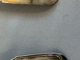two spoons and a spoon rest on a table