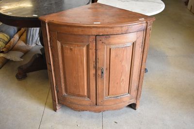 a corner cabinet with a marble top in the middle of a room