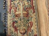 an image of a long tapestry hanging on a wall next to a chair