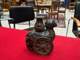 a vase sitting on a red table in the middle of a room