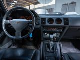 a dashboard and steering wheel of a car inside of a building