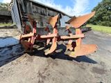 a tractor plow that is sitting in the dirt