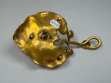 a gold object with a tag attached to it