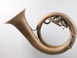 a brass instrument that is hanging on the wall