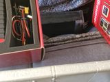 a box of electronics in the trunk of a car
