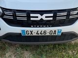 the front end of a white suv with a blue star on the hood