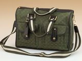 a green and black bag with a strap on it