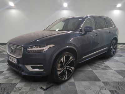 a grey volvo suv parked on a checkered floor in a garage