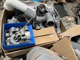 a box full of pipes and fittings in a pile