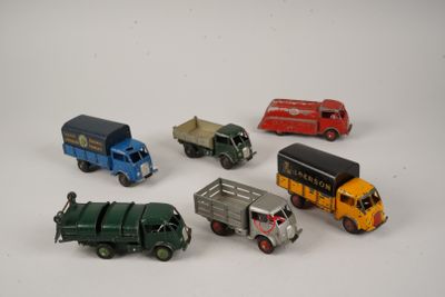several toy trucks are lined up in a circle on a white surface
