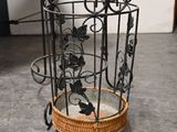 a bird cage with a bird inside of it on the floor