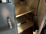 a metal cabinet with a door open in a kitchen