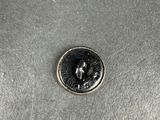 a close up of a coin sitting on top of a metal surface