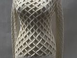 a white knitted sweater on a mannequin on a wooden stand