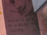 painting of a woman ' s face on the side of a building